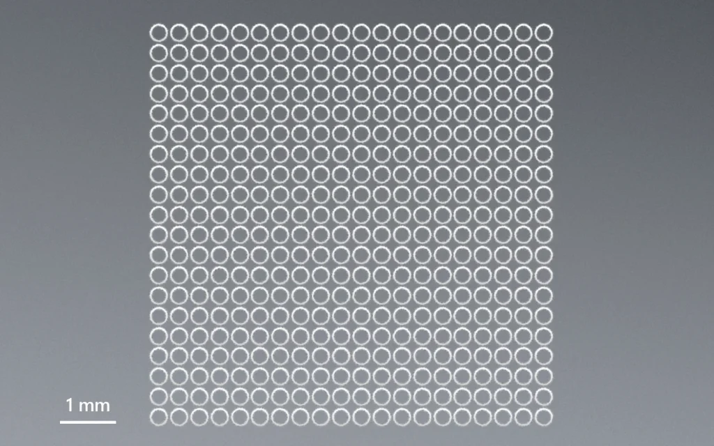 300 µm hole drilling in thin borosilicate glass.