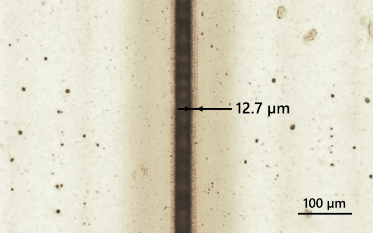 Polyimide cutting with 515 nm, indicated heat affected zone.