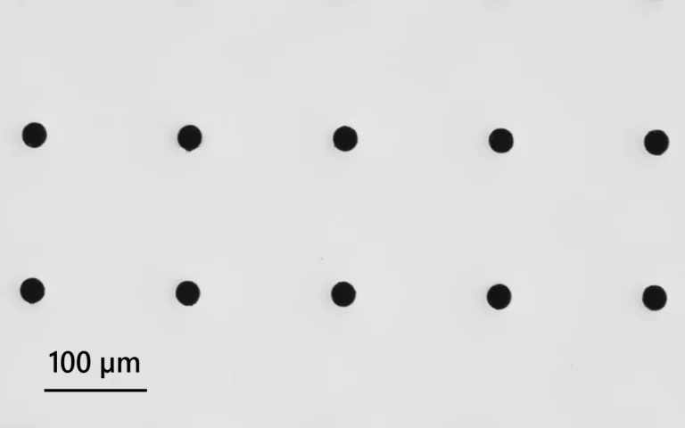 GHz burst assisted percussion drilling of high aspect ratio holes in EXG glass.