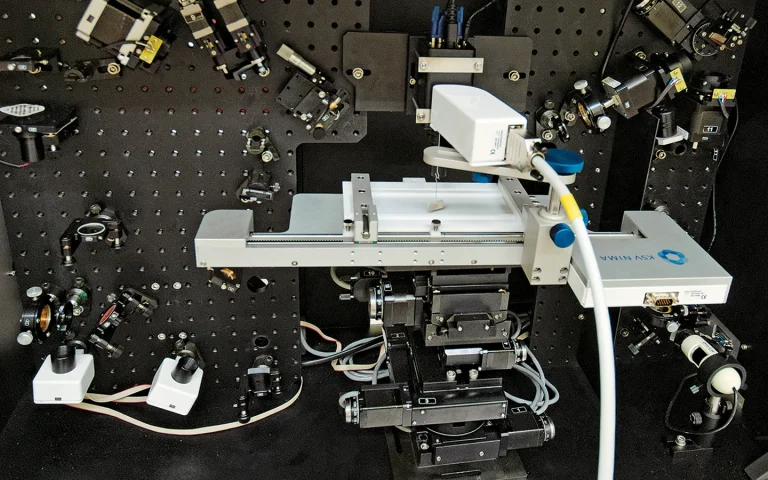 SFG spectrometer with Langmuir trough used for studies of the unique properties of molecules in monolayers
